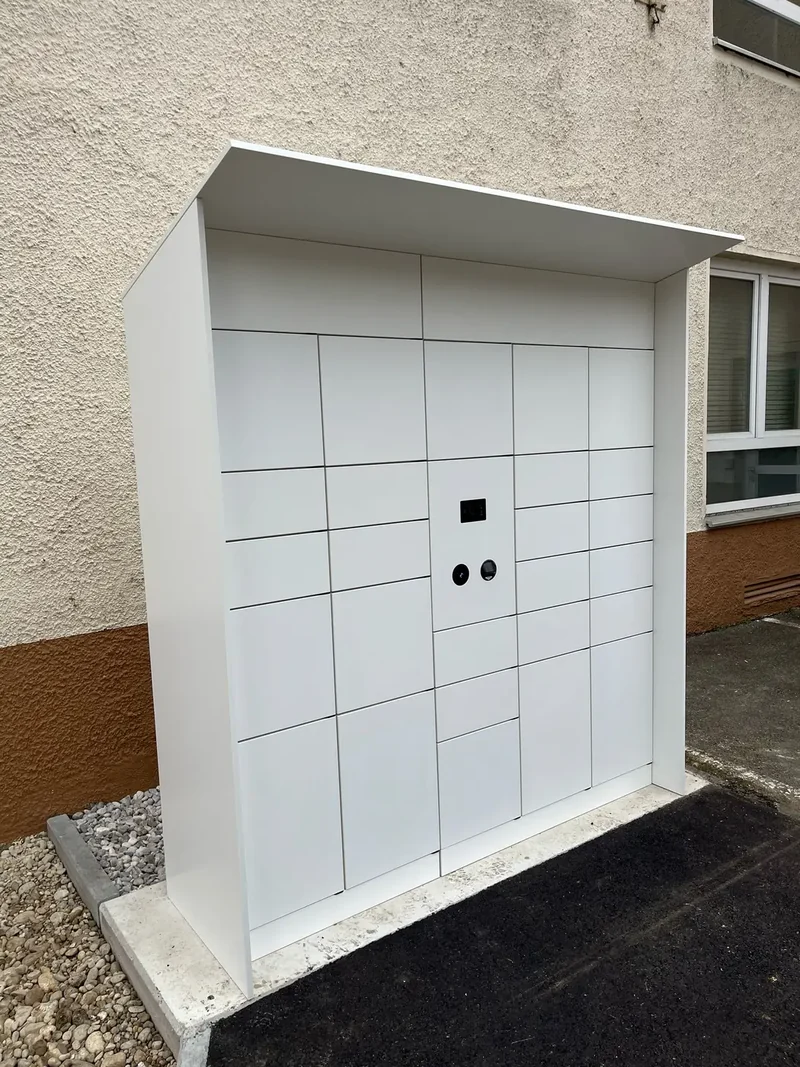 White outdoor locker bank with a protective canopy