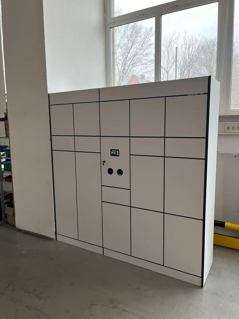 White locker installation beside tall windows